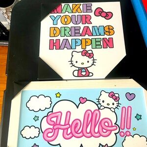 Two wall hanging signs of hello Kitty